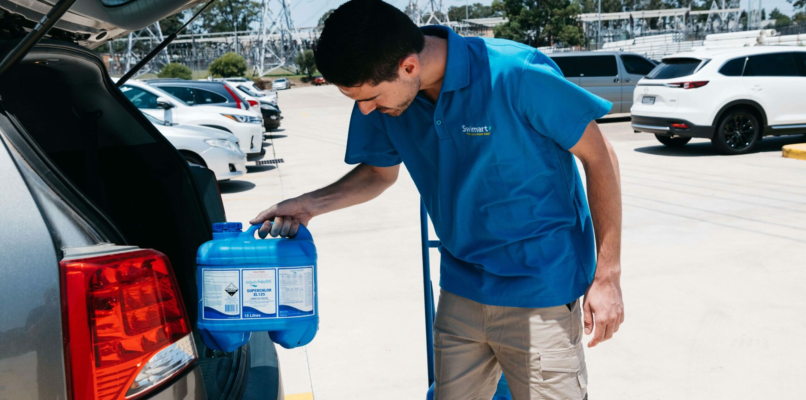 Photo of Swimart Home Pool Service Staff with pool chemical supplies